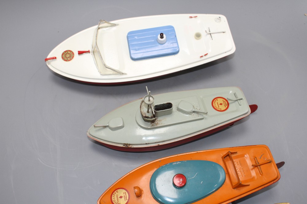 Four Sutcliffe enamelled metal model boats, comprising: two Racer I, both with clockwork, one with key, a Snappy cruiser and a Merlin